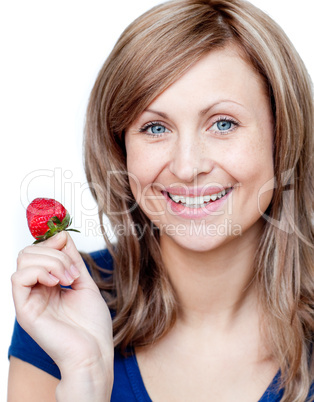Delighted woman eating strawberries