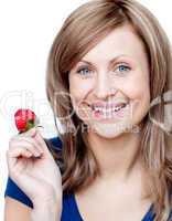 Delighted woman eating strawberries