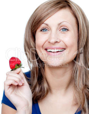 Attractive woman eating strawberries