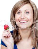 Attractive woman eating strawberries