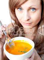 Smiling woman holding a soup bowl