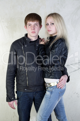 Girl and boy posing on a vintage background