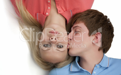 Portrait of a boy kissing his girlfriend