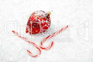 Candy Canes and Ornament lying in the snow