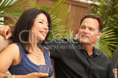 Attractive Hispanic and Caucasian Couple Drinking Wine