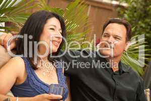 Attractive Hispanic and Caucasian Couple Drinking Wine