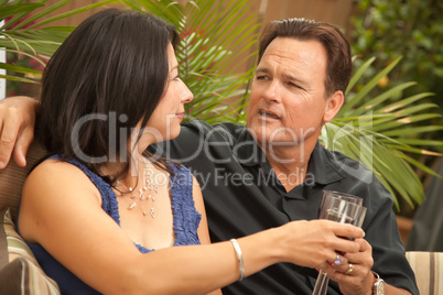 Attractive Hispanic and Caucasian Couple Drinking Wine