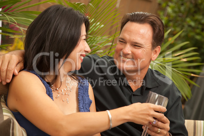 Attractive Hispanic and Caucasian Couple Drinking Wine