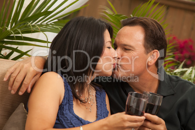 Attractive Hispanic and Caucasian Couple Drinking Wine