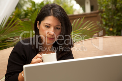 Hispanic Woman with Coffee and Laptop