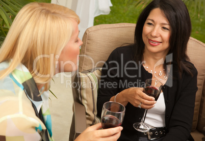 Two Girlfriends Enjoy Wine on the Patio