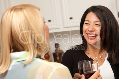 Two Girlfriends Enjoy Wine in the Kitchen