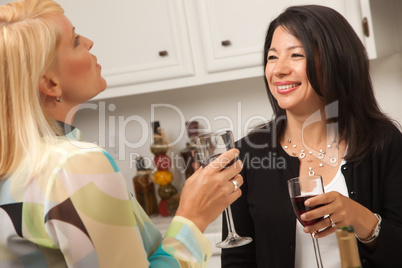 Two Girlfriends Enjoy Wine in the Kitchen