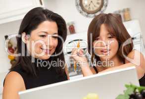 Attractive Hispanic Mother & Daughter on the Laptop