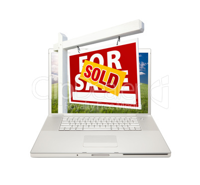 Sold For Sale Real Estate Sign on Laptop