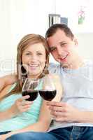 Portrait of a happy young couple drinking red wine