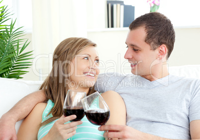 Portrait of a loving young couple drinking red wine