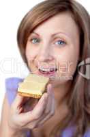 Charming woman eating a cracker with cheese