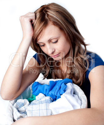 Unhappy woman doing laundry