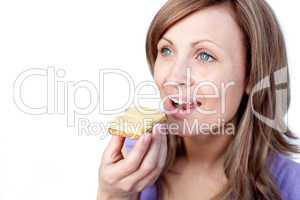 Attractive woman eating a cracker with cheese