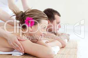 Jolly young couple receiving a back massage