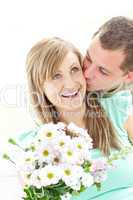 Attentive man giving a bunch of flowers to his girlfriend