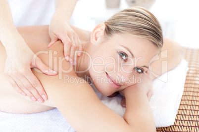 Smiling woman receiving a back massage