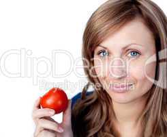 Attractive woman holding a tomato