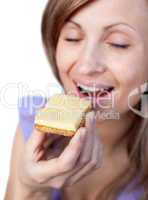 Young woman eating a cracker with cheese