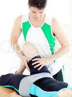 Assertive male physical therapist checking a woman's leg
