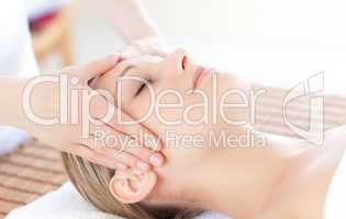 Close-up of a bright woman receiving a head massage