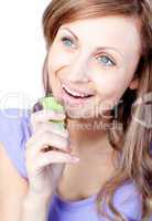 Cheerful young woman eating celery