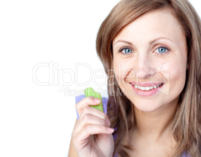 Radiant young woman eating celery