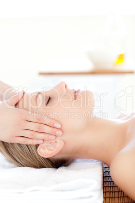 Close-up of a young woman receiving a head massage