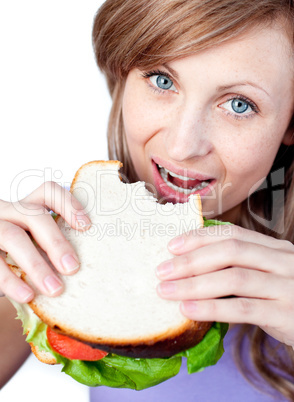 Blond woman eating a sandwich