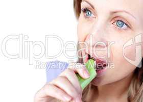 Attractive young woman eating celery