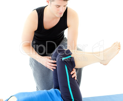 Caucasian woman exercising assited by her personal trainer