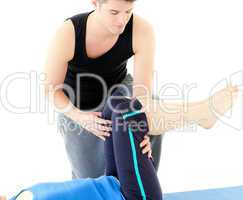 Caucasian woman exercising assited by her personal trainer