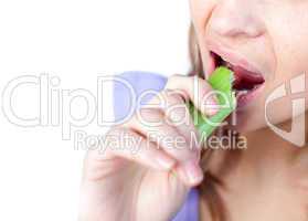 Close-up of a woman eating celery