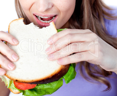Close-up of a woman eating a sandwich