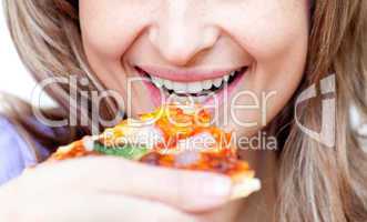 Close-up of a woman eating a pizza
