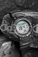 Electronic waterproof watch on grey stones