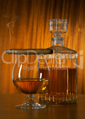 Glass of whisky with cigar