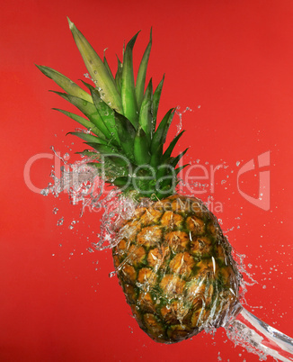 Splash in water with pineapple