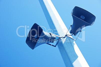 loudspeakers on a blue sky background