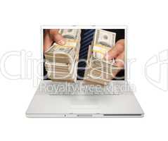 Man Handing Stacks of Money Through Laptop Screen