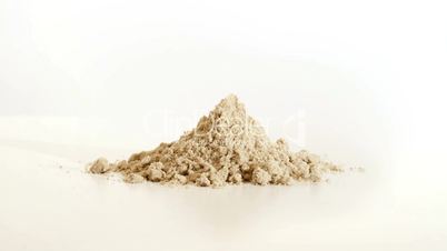A pile of sand rises from the ground and creates a sand castle