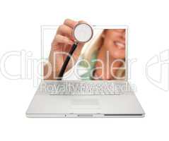 Female Doctor Holding Stethoscope Through Laptop Screen