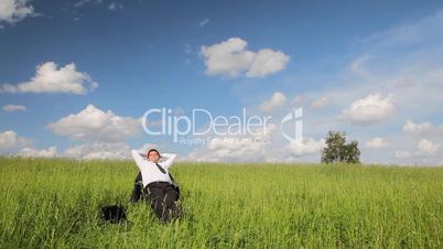 Sitting businessman throwing mobile phone