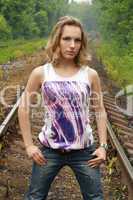 girl in jeans stands on rail